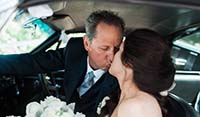 Bride and Groom kissing inside the cabin of East Coast’s  Blue Shelby 1965 Mustang Fastback